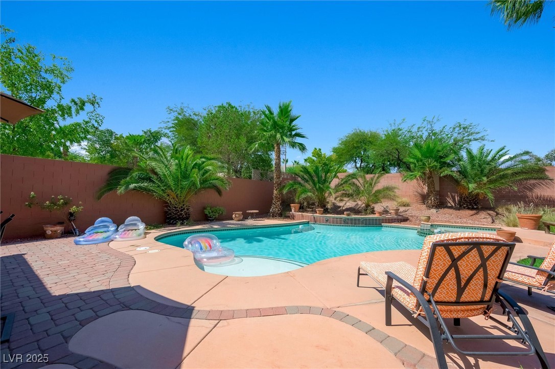 10720 Elm Ridge Avenue Las Vegas, NV 89144 - Photo 49 of 67 View of swimming pool with a fenced backyard and a patio area