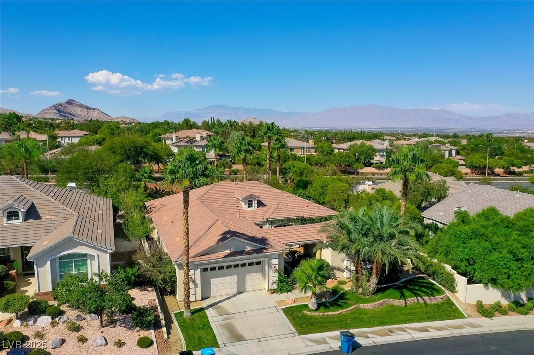 10720 Elm Ridge Avenue Las Vegas, NV 89144 - Photo 54 of 67 Aerial perspective of suburban area with a mountainous background