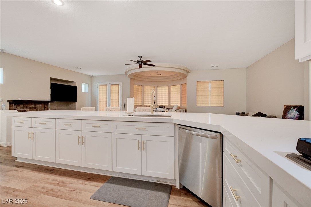 10720 Elm Ridge Avenue Las Vegas, NV 89144 - Photo 67 of 67 Kitchen featuring open floor plan, stainless steel dishwasher, white cabinets, and a ceiling fan