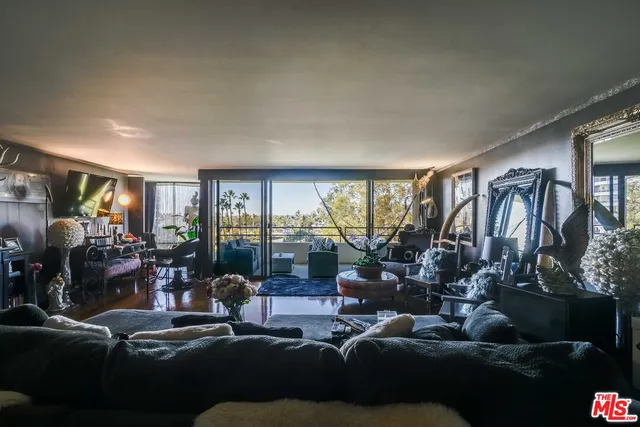 a bedroom with two beds and a painting on the wall