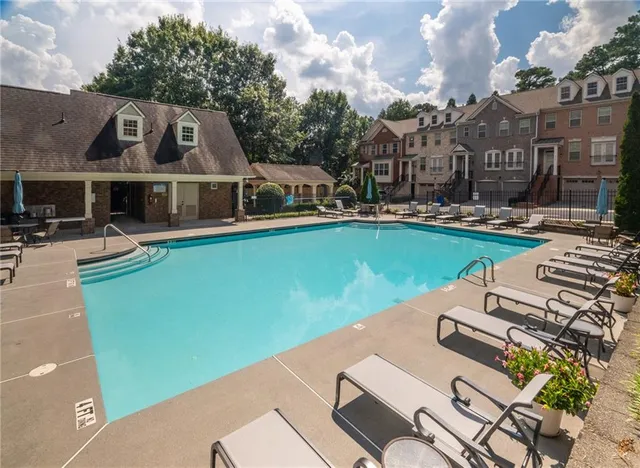 a front view of a house with swimming pool garden and patio
