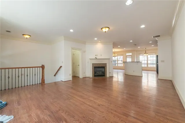 a view of a big room with wooden floor and a fireplace