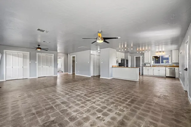 a view of a kitchen with a sink and a kitchen floor