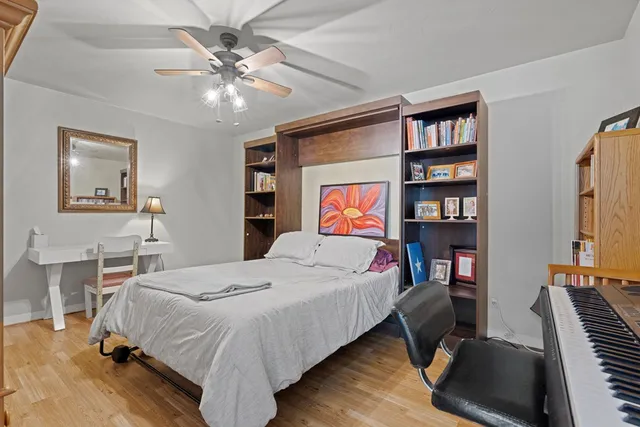 a bedroom with a bed furniture and a book shelf