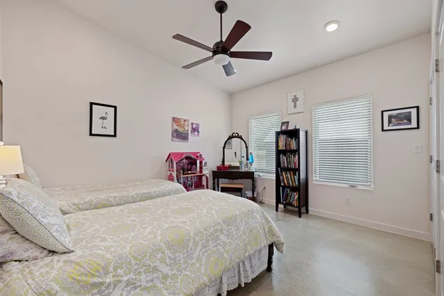 a bed room with a bed and a chair