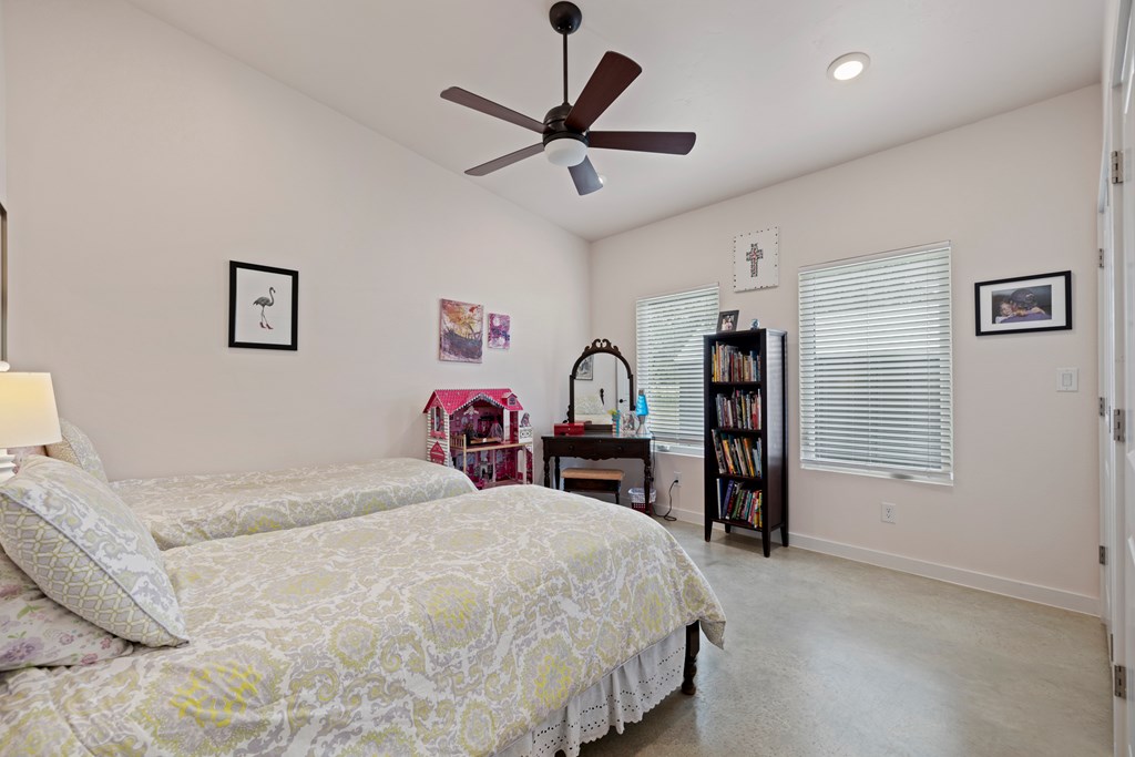 713 Ranch Road 1320 Hye, TX 78635 - Photo 14 of 26 a bed room with a bed and a chair