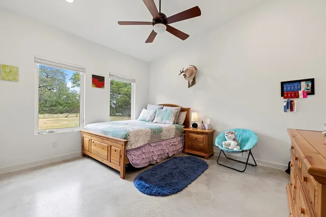 a living room with a bed furniture and a window