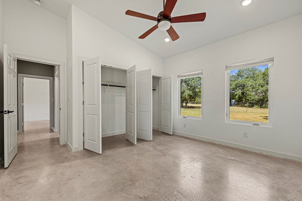 713 Ranch Road 1320 Hye, TX 78635 - Photo 17 of 26 a view of empty room with window and ceiling fan