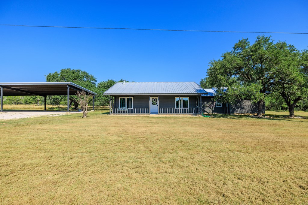713 Ranch Road 1320 Hye, TX 78635 - Photo 5 of 26 a front view of a house with a swimming pool