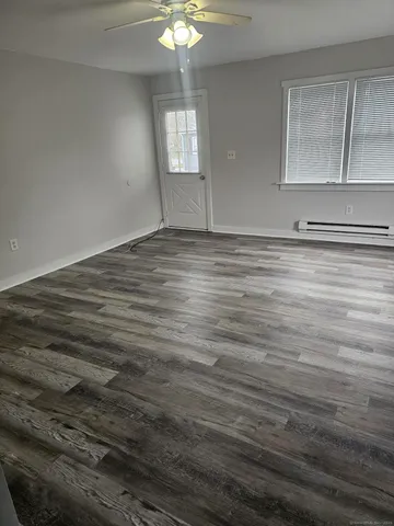 a view of empty room with window and fireplace