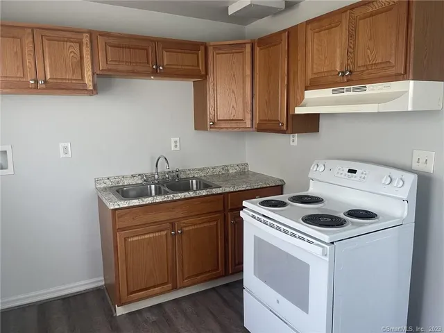 a kitchen with appliances cabinets and a counter top space