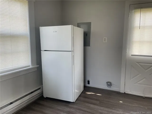 a white refrigerator freezer sitting in a kitchen