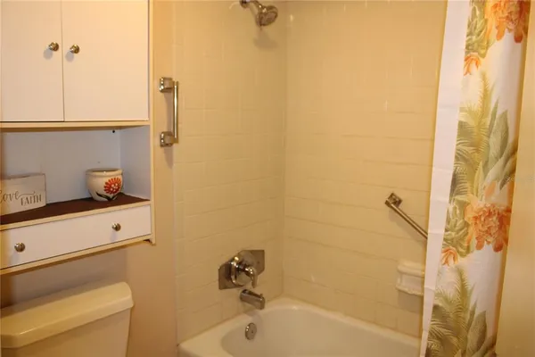 a bathroom with a tub and a shower