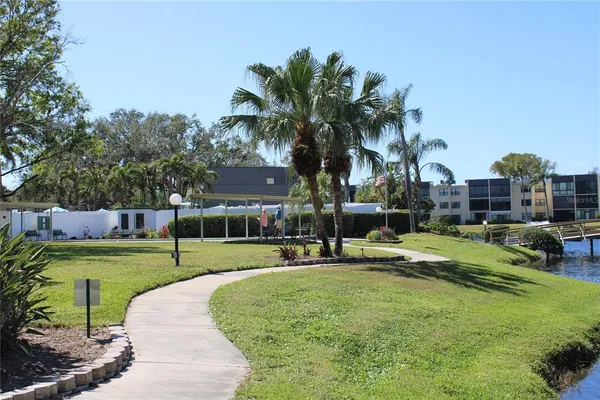 a swimming pool with outdoor seating and yard