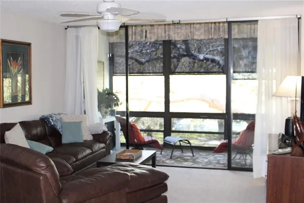 a living room with furniture and a floor to ceiling window