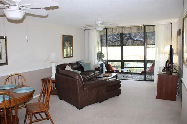 a living room with furniture and a floor to ceiling window