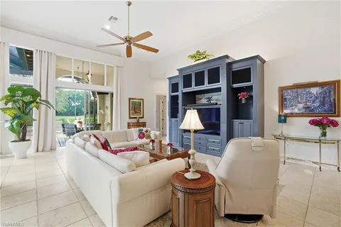 a living room with furniture a ceiling fan and a window