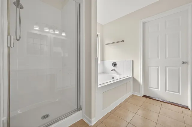 a bathroom with a bathtub and shower