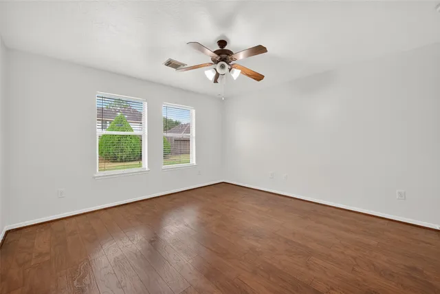 wooden floor in an empty room with a window