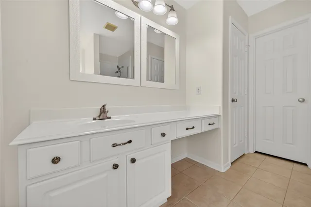 a bathroom with a sink and mirror