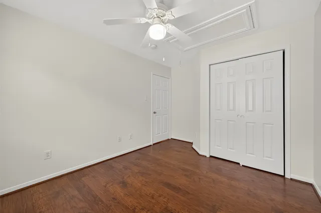 an empty room with fan and entrance