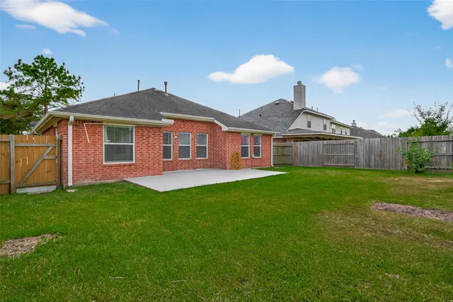 a front view of a house with yard and green space