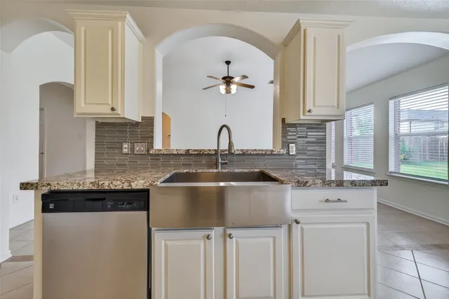 a kitchen with cabinets a sink and appliances