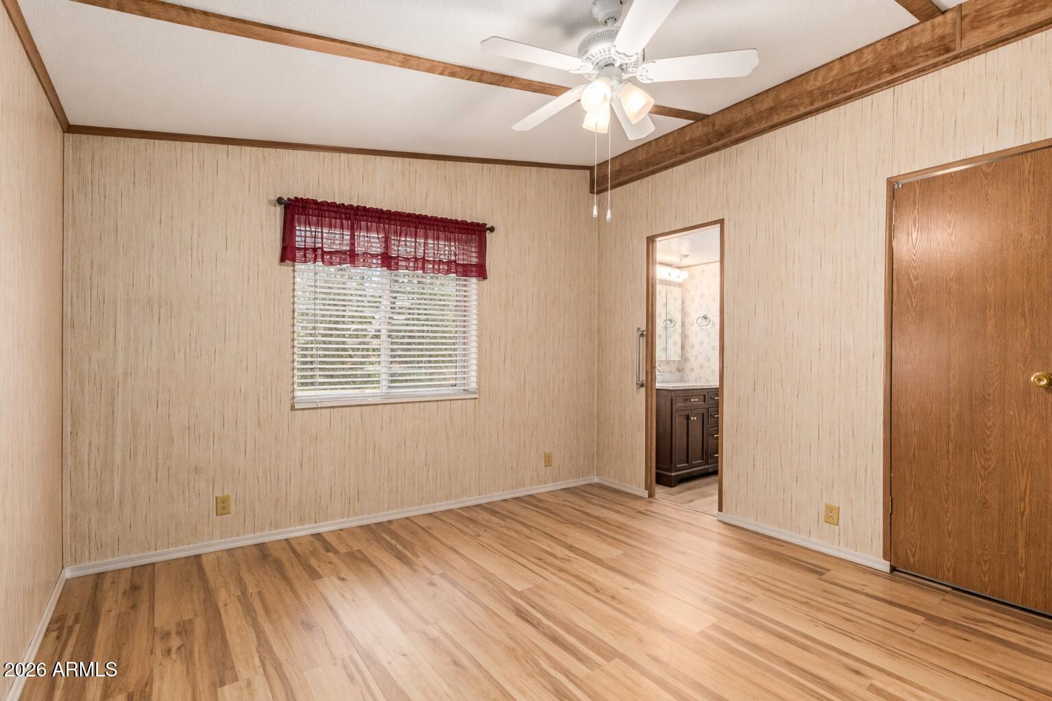 53 North Mountain Road, Unit 54 Apache Junction, AZ 85120 - Photo 18 of 35 Neutral-toned empty bedroom with wood tr