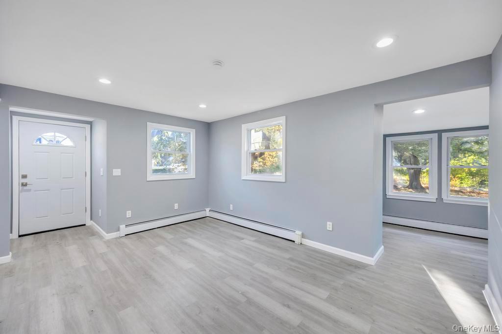 231 Elm Road West Mastic Beach, NY 11951 - Photo 14 of 34 an empty room with windows and closet