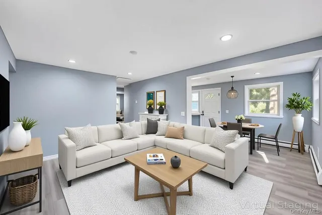 a living room with furniture and a wooden floor