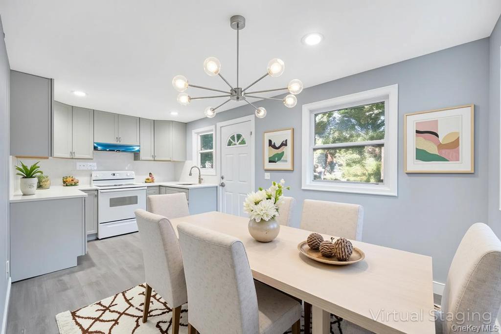 231 Elm Road West Mastic Beach, NY 11951 - Photo 20 of 34 a kitchen with a table chairs stove and microwave