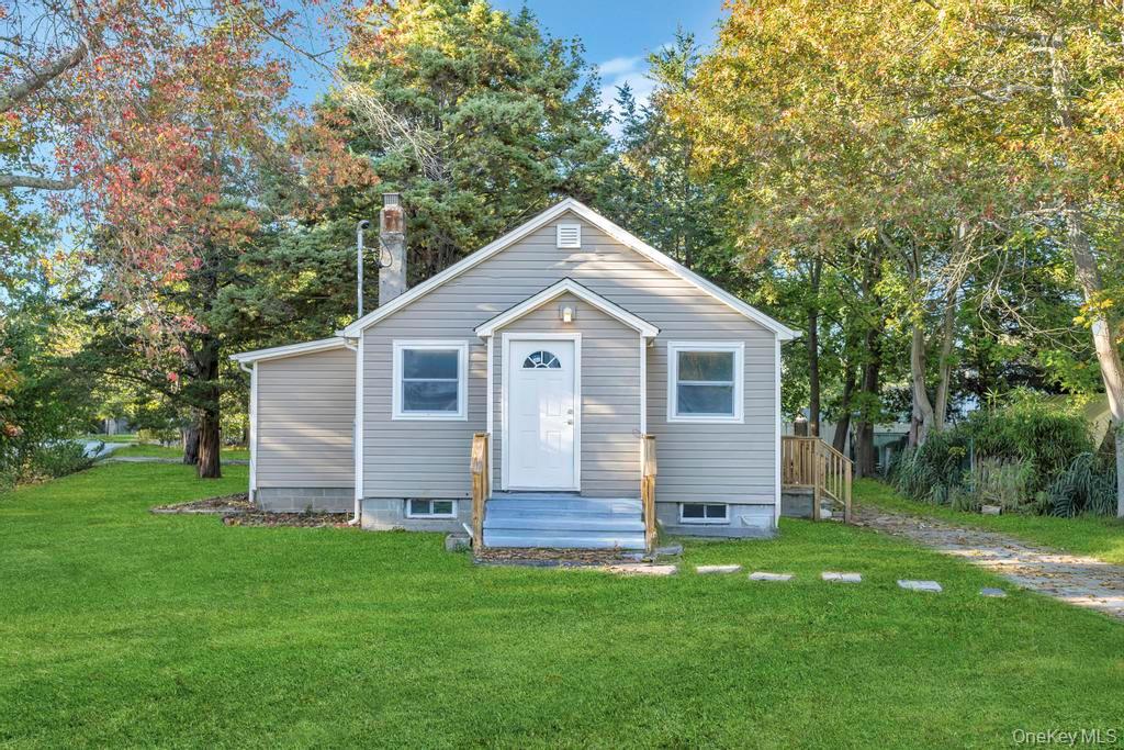 231 Elm Road West Mastic Beach, NY 11951 - Photo 2 of 34 a front view of house with a garden