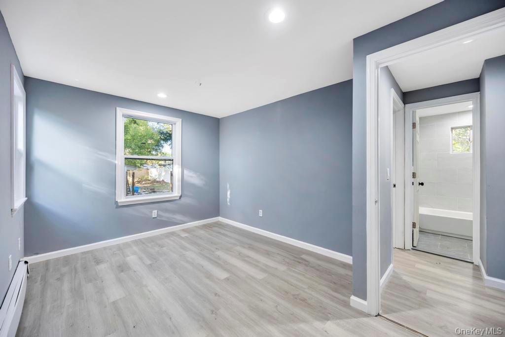231 Elm Road West Mastic Beach, NY 11951 - Photo 23 of 34 a view of an empty room with window and closet area