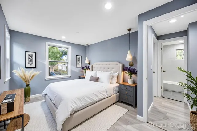 a view of an empty room with window and closet area