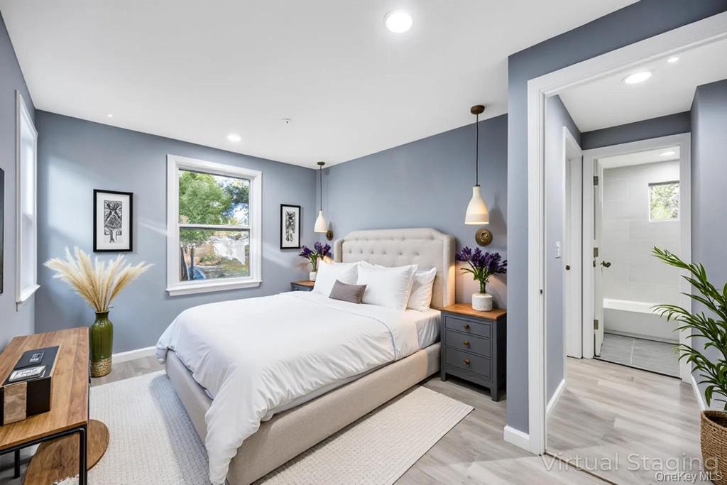 231 Elm Road West Mastic Beach, NY 11951 - Photo 24 of 34 a bedroom with a bed and a window