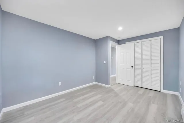 a view of room with window and hardwood floor