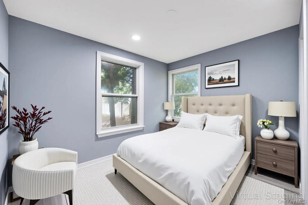 231 Elm Road West Mastic Beach, NY 11951 - Photo 28 of 34 a bedroom with a bed a mirror and a window