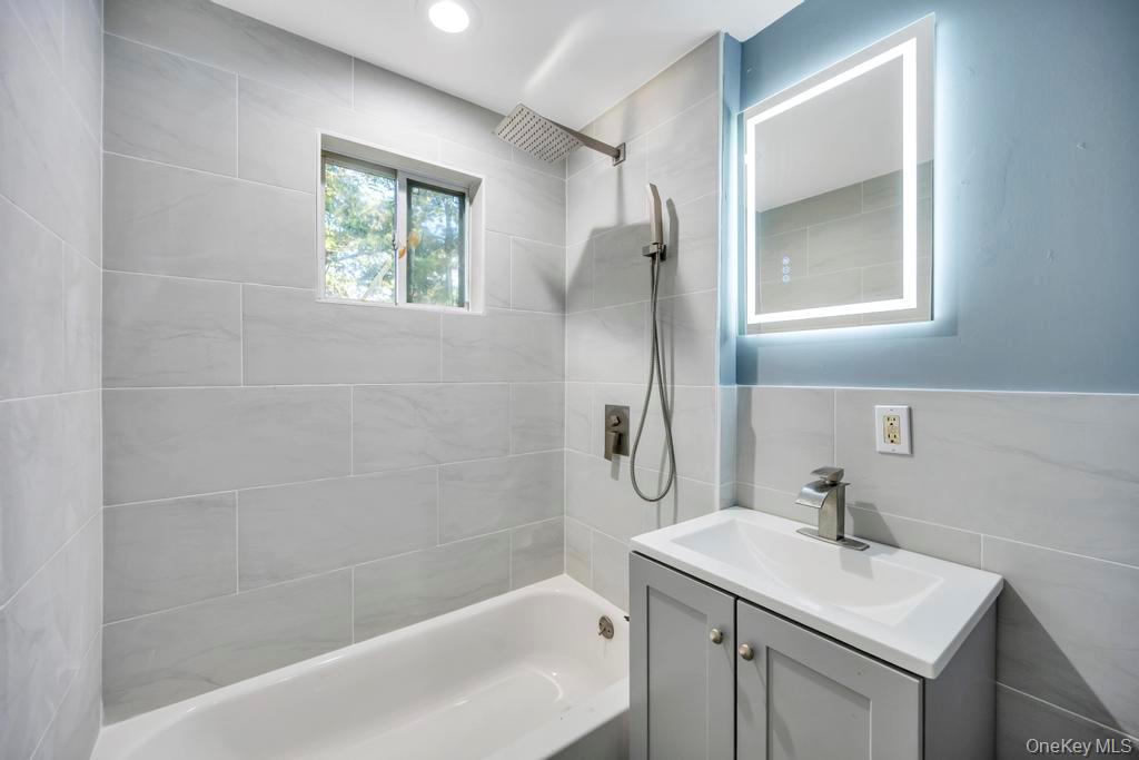 231 Elm Road West Mastic Beach, NY 11951 - Photo 30 of 34 a bathroom with a sink toilet and vanity