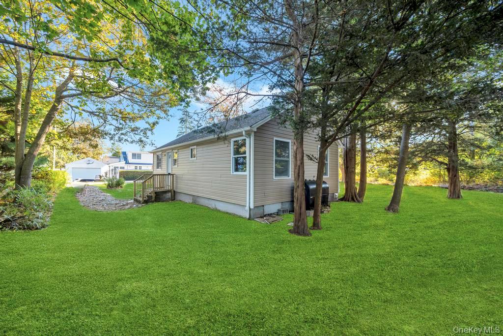 231 Elm Road West Mastic Beach, NY 11951 - Photo 10 of 34 a view of a backyard with large trees