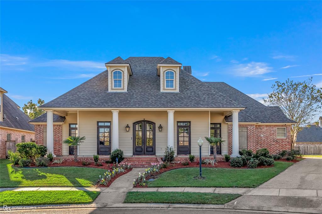 a front view of a house with garden