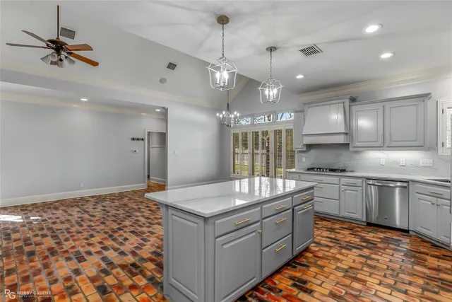 a kitchen with a stove a sink and a refrigerator