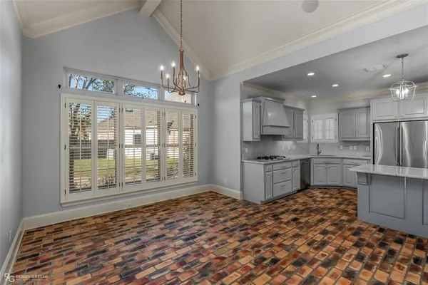 a kitchen with stainless steel appliances granite countertop a refrigerator and a stove top oven