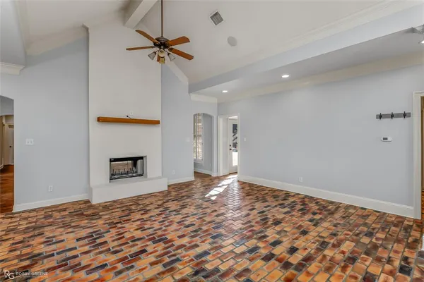a view of a livingroom with a ceiling fan and wooden floor