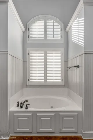 a bathroom with a bathtub and next to a window