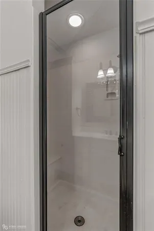 a bathroom with a glass shower door