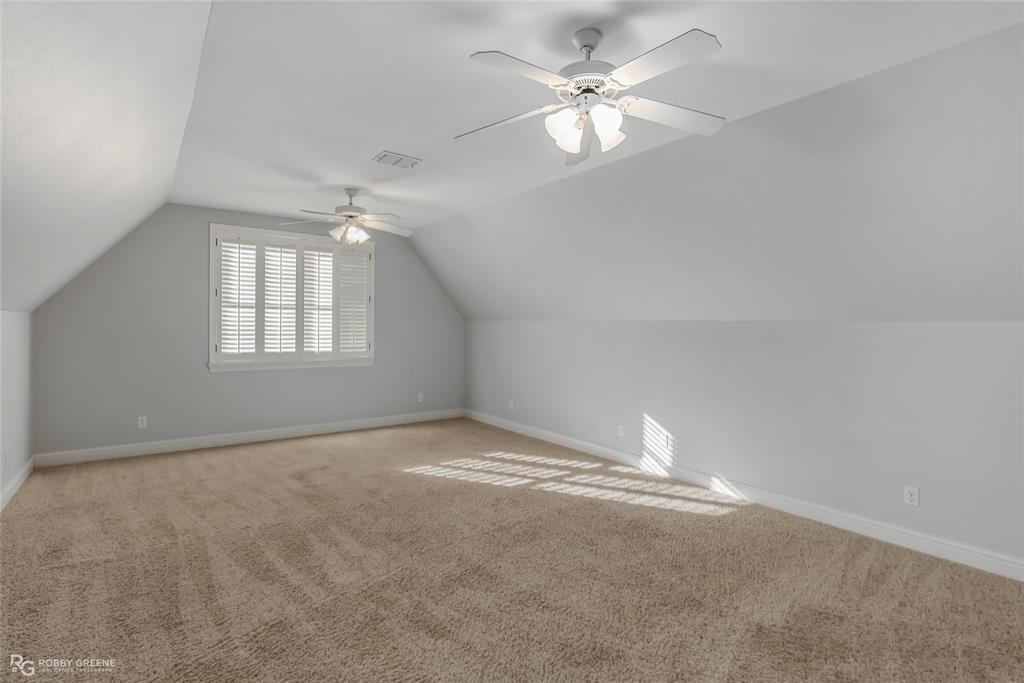 1012 Conti Circle Shreveport, LA 71106 - Photo 31 of 40 an empty room with chandelier fan and windows