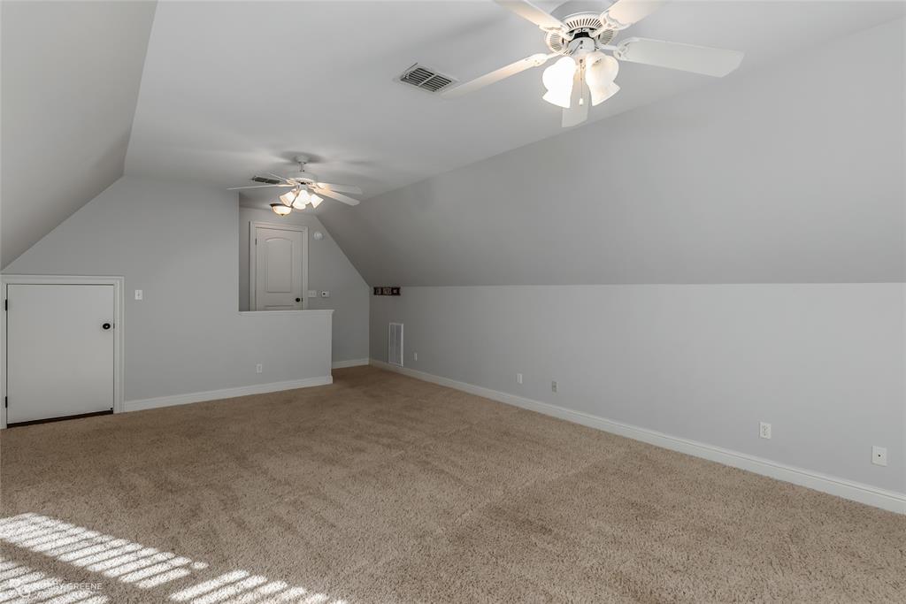 1012 Conti Circle Shreveport, LA 71106 - Photo 32 of 40 an empty room with a chandelier fan and windows