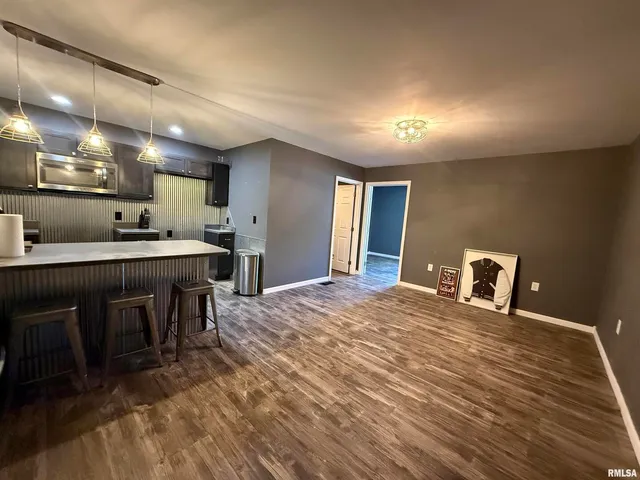 a kitchen with a table and chairs