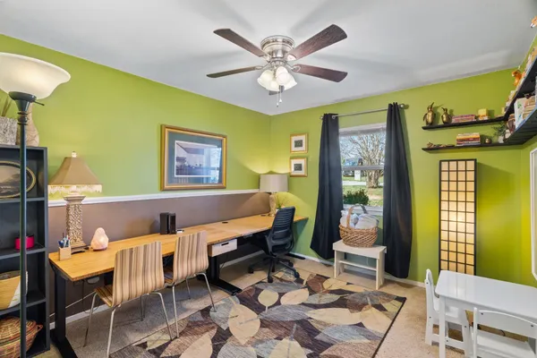 a view of a dining room with furniture and chandelier