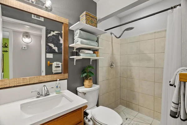 a bathroom with a sink toilet and shower